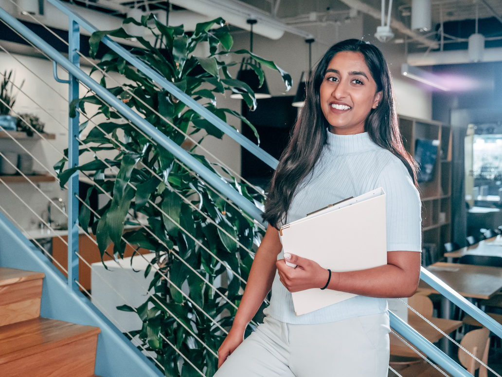 Female Employee leaning on Handrails